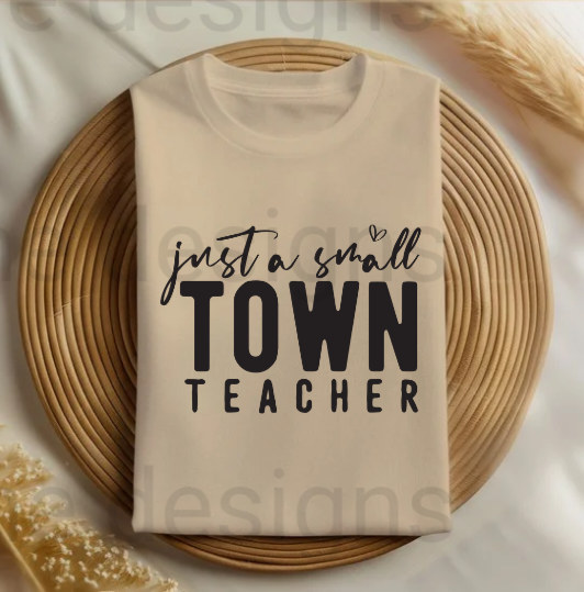 Celebrate the hard work of small-town educators with this "Just a Small Town Teacher" t-shirt! Made from soft, comfy fabric, this aesthetic teacher shirt is perfect for everyday wear in the classroom or out and about. The charming design shows pride in being a dedicated teacher, making it a great gift for Teacher Appreciation Week or any special occasion.