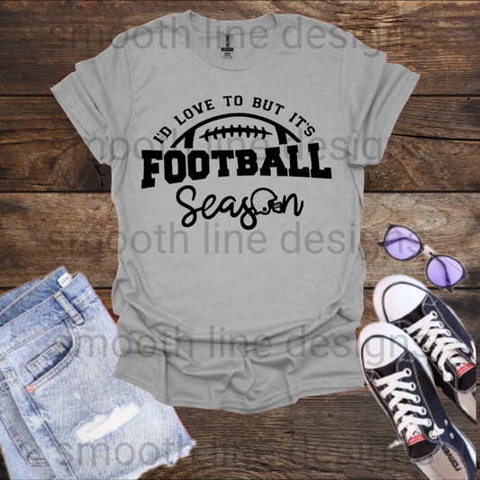 Celebrate your love for football with this fun "I'd Love to But It's Football Season" t-shirt! Made from soft, comfortable fabric, this shirt is perfect for game days, whether you’re cheering from the stands or watching from home.